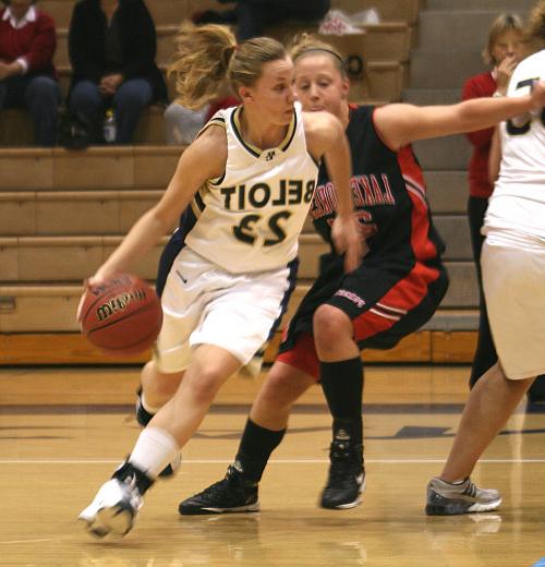 Mary Parker'10 dribbling a basketball down the court.